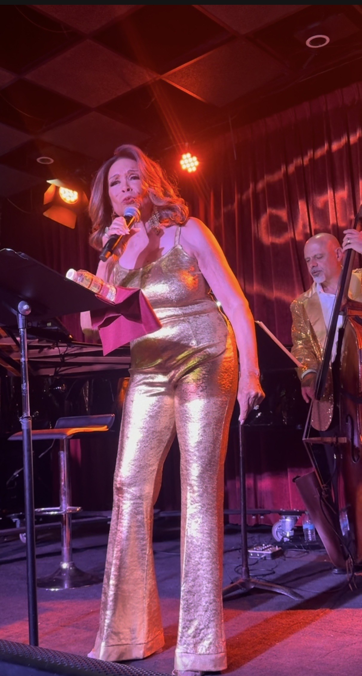 Freda Payne in a gold lame halter and flares under red stage light at Catalina Jazz Club